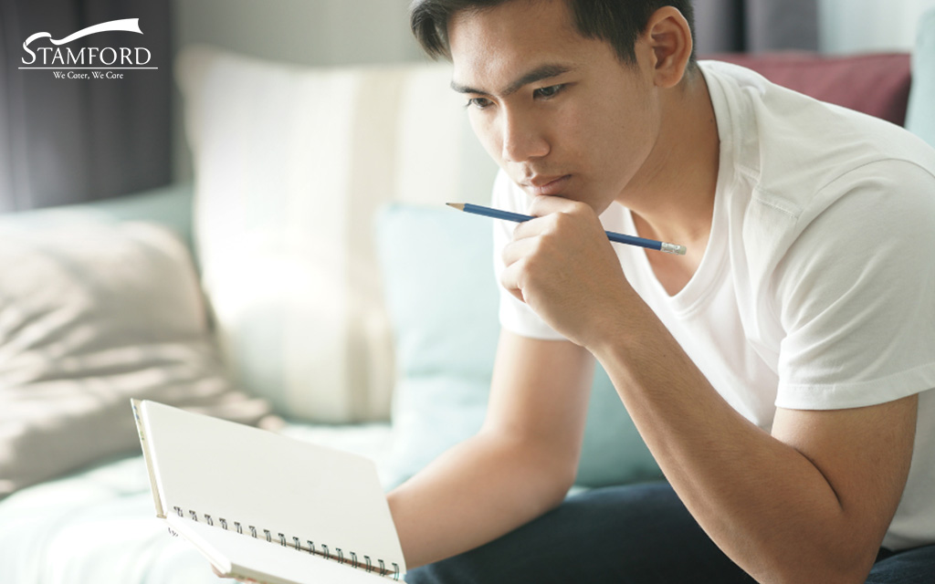 Man Thinking About Something And Holding A Notebook