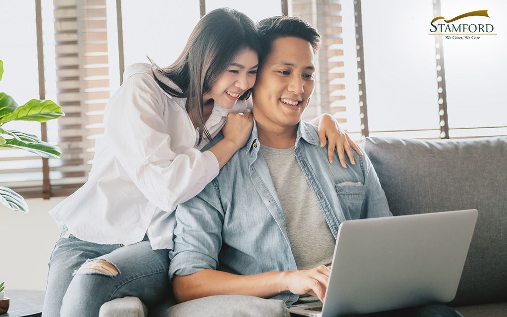 Image of a young Asian couple using a laptop