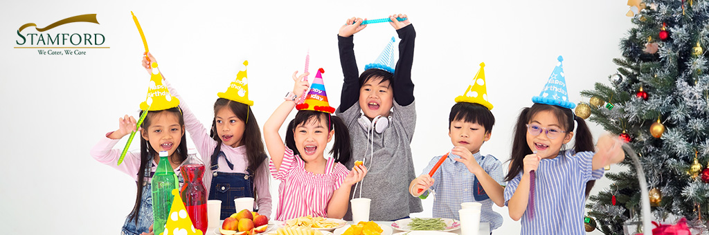 Kids celebrating with party hats and snacks.