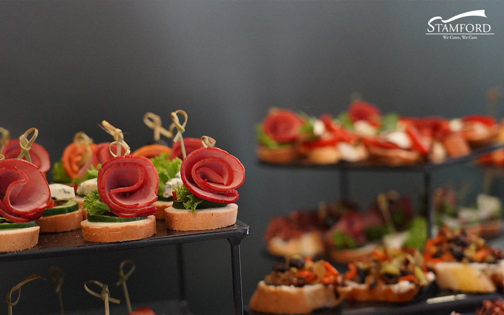 Elegant canapés with ham rolls for wedding catering.