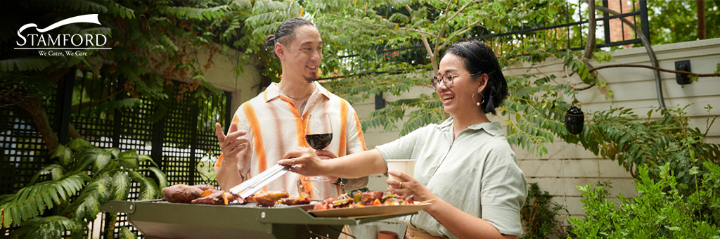 Friends grilling meat at a BBQ party.