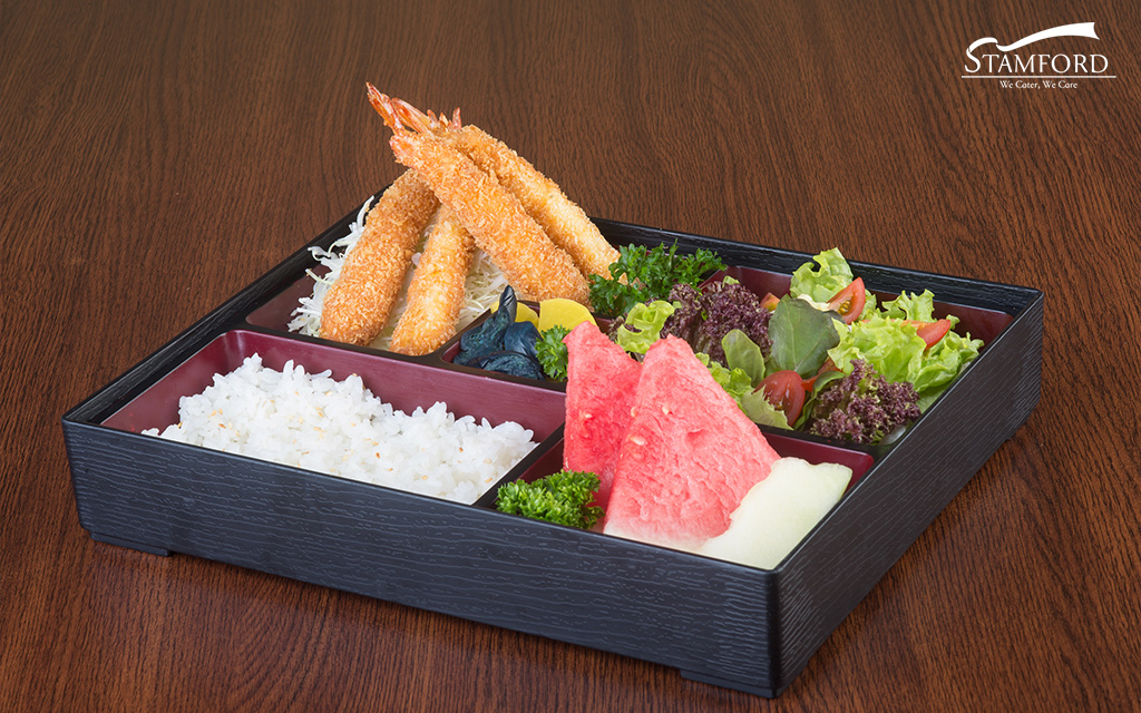 Japanese bento box with fried shrimp and rice.